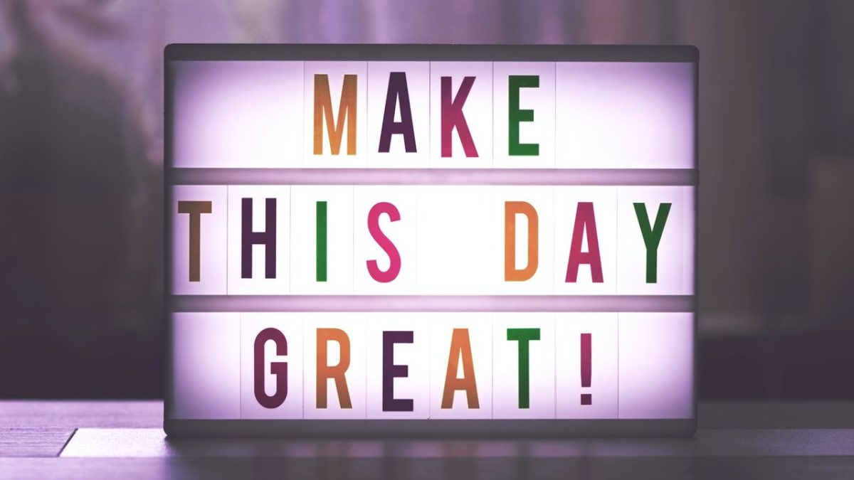 Colorful board with the words "make this day great!" on it