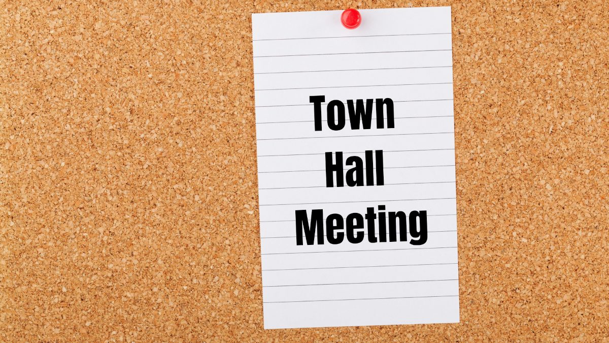 town hall meeting sign on cork board