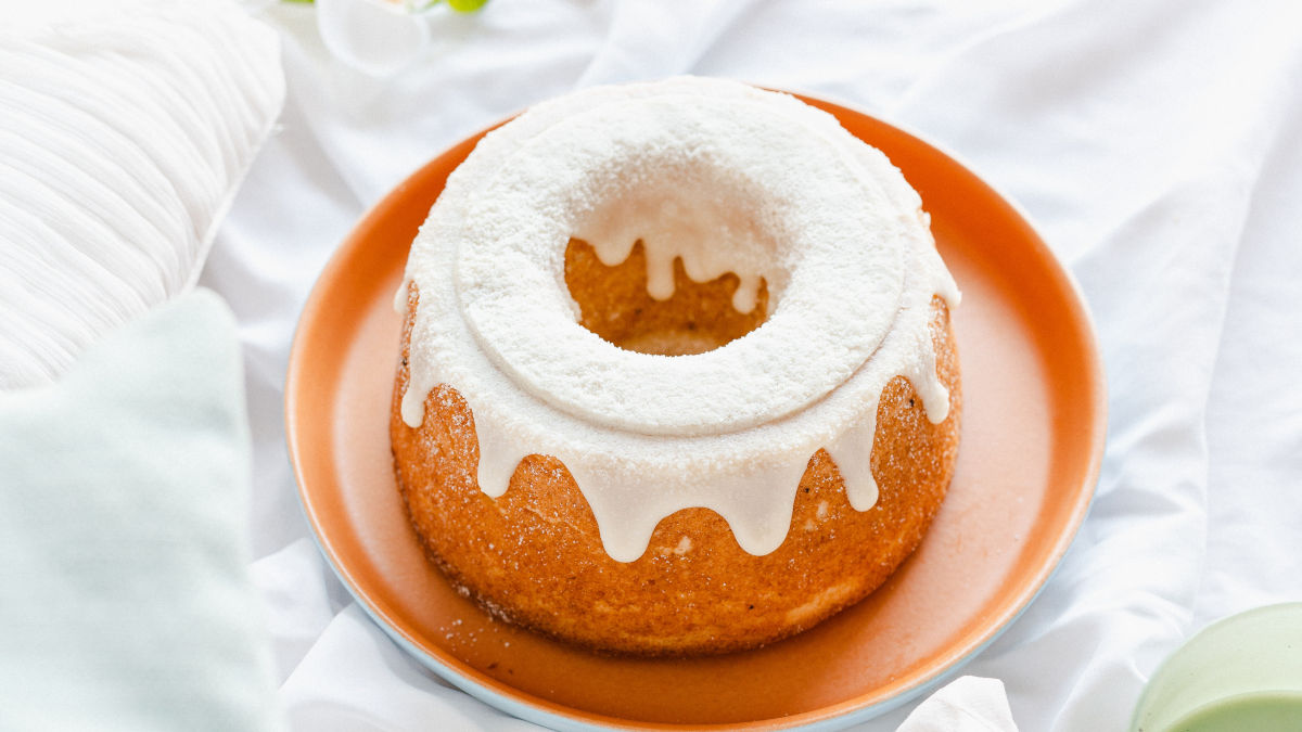 bundt cake with white frosting on a tray