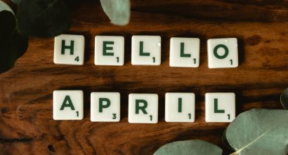"hello April" spelled in tiles on a brown background