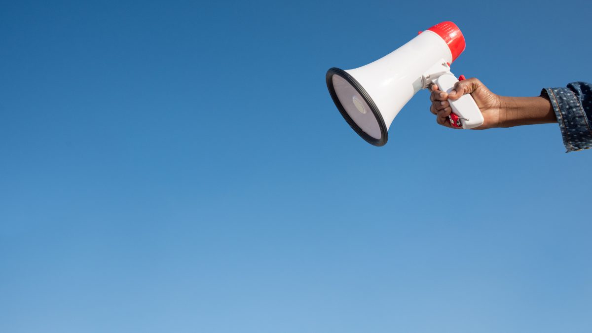 image of a megaphone being held against a blue sky