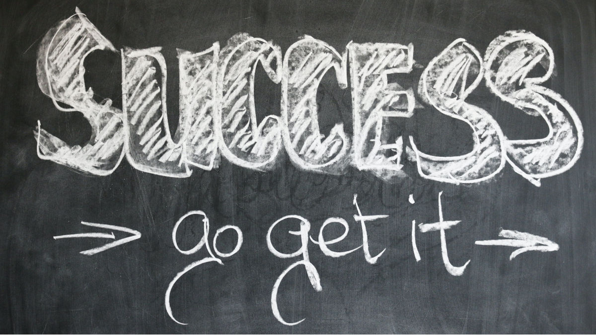 chalkboard with "success go get it" written on it in white chalk