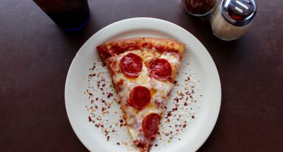 a slice of pepperoni pizza on a plate