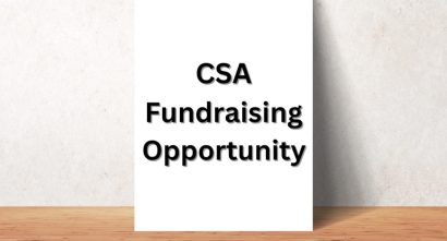 white sign that reads "CSA Fundraising Opportunity" in black text
