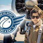 Young aviator standing in front of an airplane