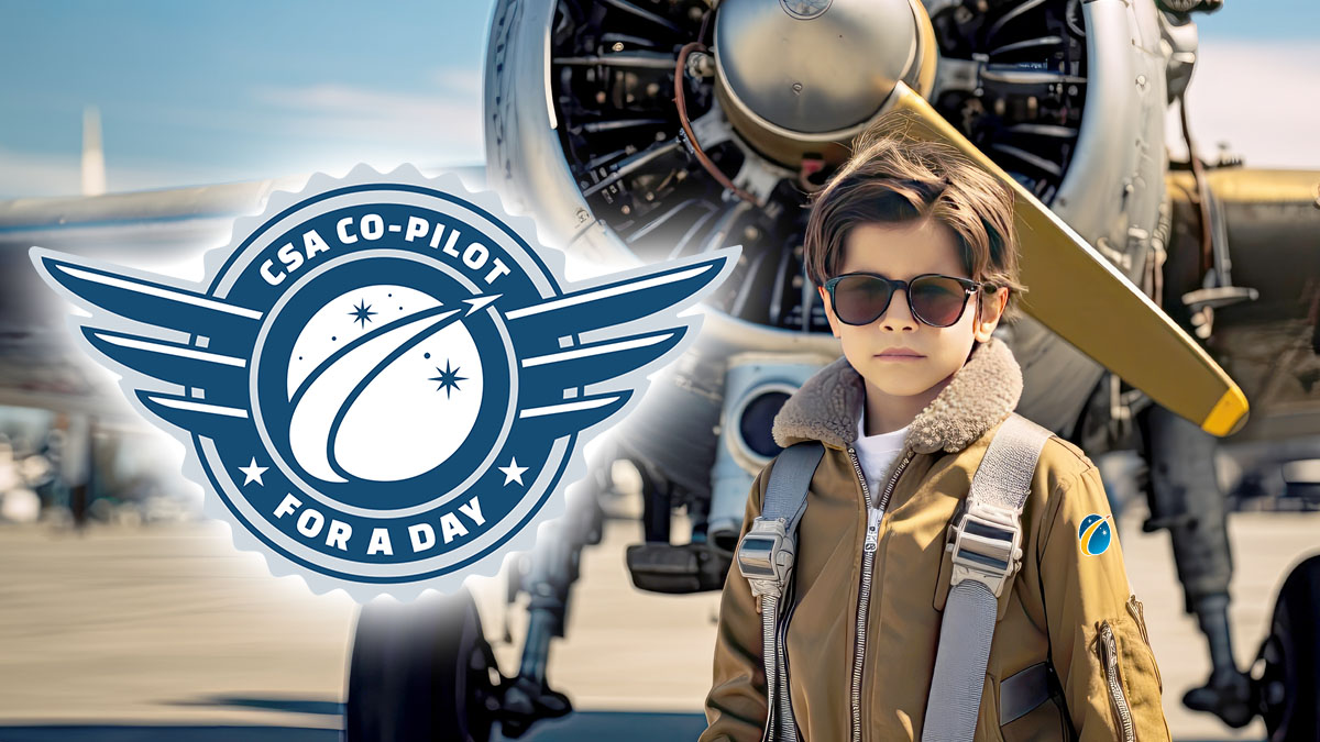 Young aviator standing in front of an airplane